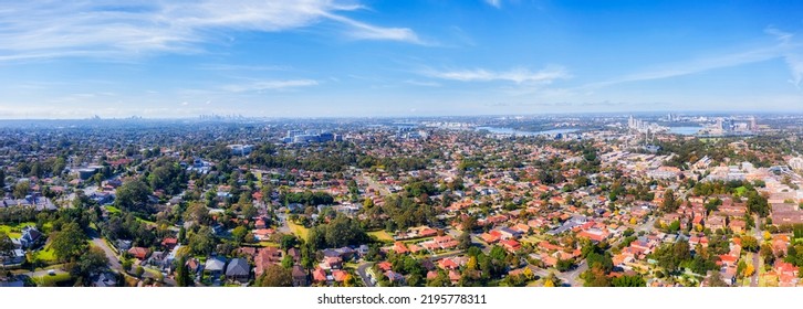 Western Sydney City Of Ryde Suburbs In Greater Sydney Area Along Parramatta River - Aerial View Towards Distant City CBD Skyline.