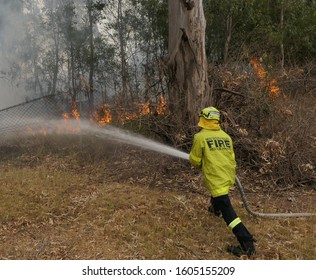 Western Sydney, NSW Australia, January 1, 2020: Closeup Of Firefighters Battling An Out Of Control Grass Fire.