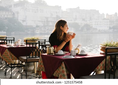 Western woman having a teatime at a cafe in Udaipur