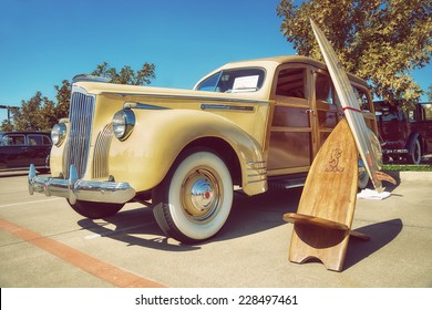 WESTLAKE, TEXAS - OCTOBER 18, 2014: A Yellow 1941 Packard 110, Wood Bodied Station Wagon, Is On Display At The 4th Annual Westlake Classic Car Show. Front Side View. Vintage Style Effects.