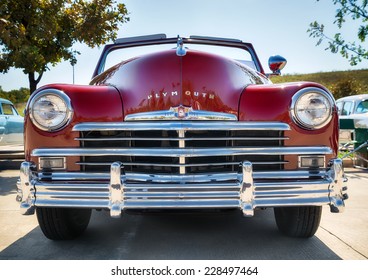 WESTLAKE, TEXAS - OCTOBER 18, 2014: A red 1949 Plymouth is on display at the 4th Annual Westlake Classic Car Show. Closeup of front view.