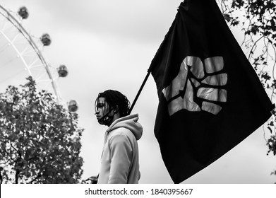 WESTMINSTER, LONDON/ENGLAND- 18 October 2020: END SARS Protester With A BLM Flag Outside New Scotland Yard In London