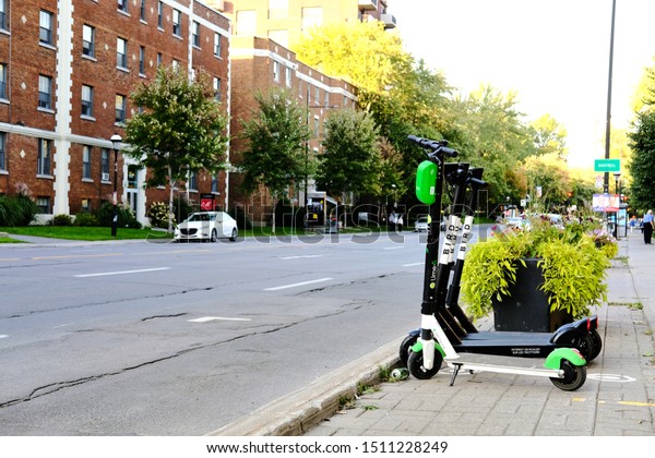 Westmount, Canada - September 21, 2019: Lime and\
Bird e-scooters parked in designated parking area. City of Montreal\
allowed the Californian young companies\' operation as a part of\
pilot project.