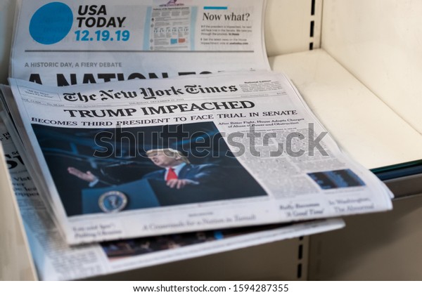 Weston,\
Florida/USA - December 20, 2019: Morning newspapers on the stand at\
local Gas station. A couple of Newspapers with top news about\
President Donald J. Trump\
Impeachment.
