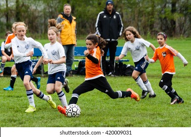 Westport, CT, USA - May 8, 2016: Daytime scene of young girls in an all girls team in Westport, Connecticut on May 8, 2016 while playing an organized youth soccer game
