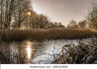 Westport Lake On Winter Day.Stoke On Trent ,Staffordshire,Uk.Sun Reflection In Frozen Pond.Staffordshire Landscape,uk.T