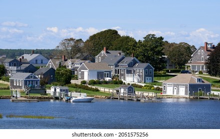 Westport Point, MA, USA - September 11, 2021: Waterfront houses in this historic coastal village on a clear summer day. Weathered cedar shingles with white painted trim are the typical house style.