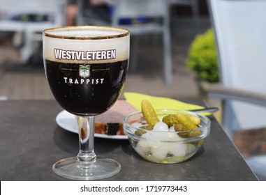 WESTVLETEREN, BELGIUM – MAY 5 2014: limited available strong dark trappist served in the appropriate glass in the café next to the abbey where it is brewed. Elected best beer of the world 