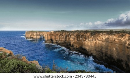 Westwards view in the early morning coming from Island Arch Lookout along Loch Ard Gorge to Mutton Bird Island, also known as The Sow, next to Port Campbell in the Shipwreck Coast. Victoria-Australia.