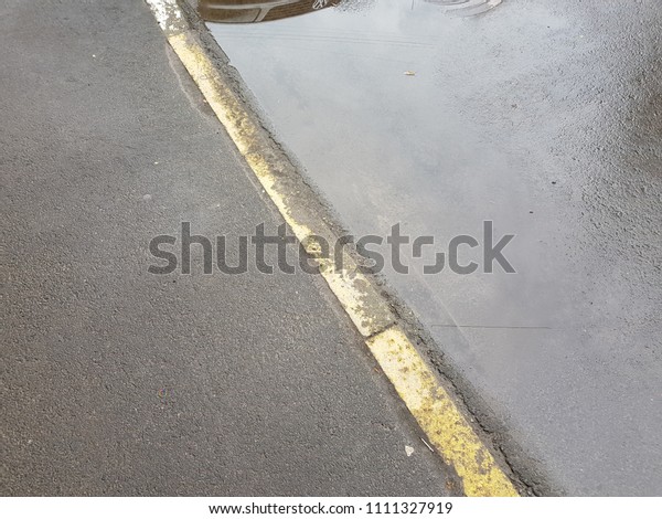 Wet asphalt,\
puddles