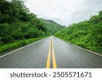 Wet asphalt road with beautiful view of landscape