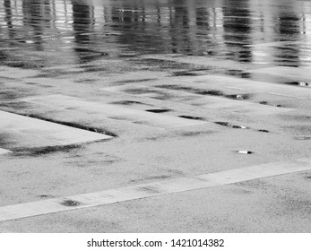 wet asphalt road with line of crosswalk after rain