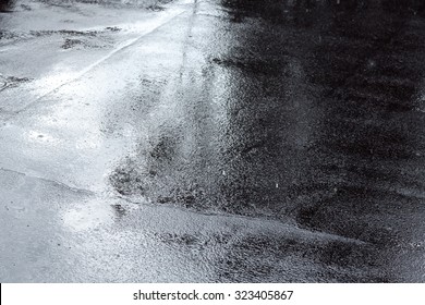 wet asphalt sidewalk background after heavy rain  soft focus