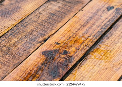 Wet Brown Wooden Planks Of Wooden Brown Terrace. Surface Of Organic Wood Floor With Many Rainy Puddles After Heavy Rain Or Thunderstorm. Abstract Low Angle Stock Photography Background