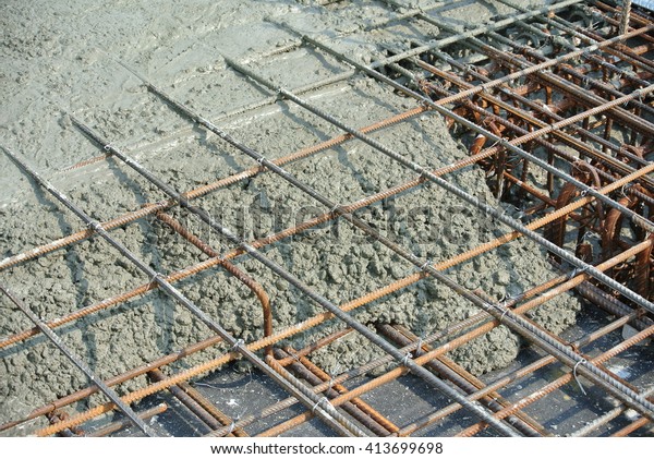 The wet concrete is poured on a steel\
reinforcement to form strong floor\
slabs.