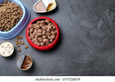 Wet And Dry Pet Food On Grey Table, Flat Lay. Space For Text