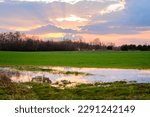 wet farmland. wet meadows. A large puddle in an agricultural field. marshy farmland. flooding of meadows and fields in the spring.agricultural landscape in early spring. Agricultural fields sown.