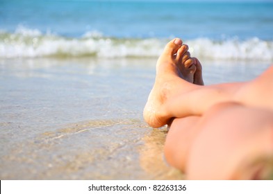 Wet Female Feet On The Beach And Sand