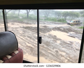 Wet Flooded Road. Soil Erosion After Storm, View Thru The Sliding Window Of Four-wheel Drive Safari Vehicle At Serengeti National Park In Tanzania, East Africa