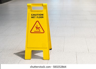 Wet Floor Caution Sign On Pathway In Office