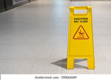 Wet Floor Caution Sign On Pathway In Office.