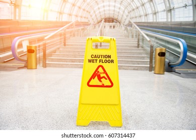 Wet floor caution sign on hotel corridor floor. - Shutterstock ID 607314437