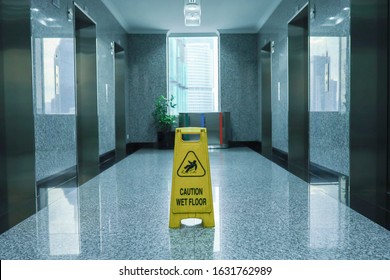 Wet Floor Signage At An Office Lobby 