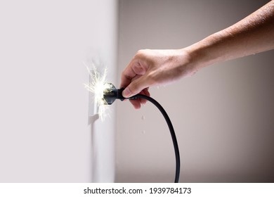 Wet Hand Connecting Electrical Plug Cause Electric Shock, Idea For Causes Of Home Fire, Electric Short Circuit, Electrical Hazard Can Ignite Household Items, Residential Building Electrical Fires.