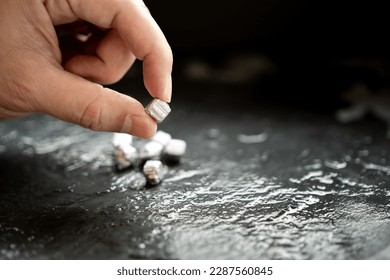 The wet man's hand was holding silver, or platinum, or rare earth minerals. - Shutterstock ID 2287560845