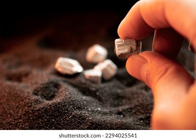 The wet man's hand was holding silver, or platinum, or rare earth minerals.