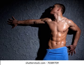 Wet Muscular Man Wrapped In A Towel