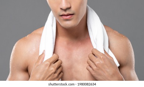 Wet Muscular Shirtless Man With White Towel Around His Neck In Isolated Light Gray Studio Background For Men Skin Care And Beauty Concepts