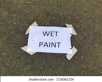 Wet Paint Sign Plastered To A Wall With Sticky Tape. 