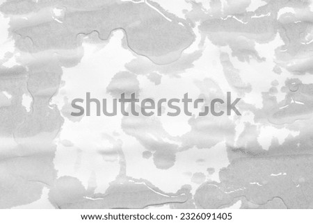 Wet paper texture with wet spots. Empty sheet of wet paper with surface texture. Full frame