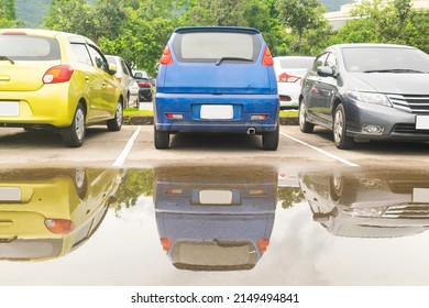 Wet Parking Lot With Car Parking In A Row. Cars Park In Open Parking Lot After Rain. Transportation In Rainy Season
