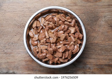 Wet Pet Food In Feeding Bowl On Wooden Table, Top View