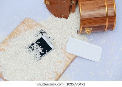 Wet Phone In Rice On Wood And Bucket Rice Background