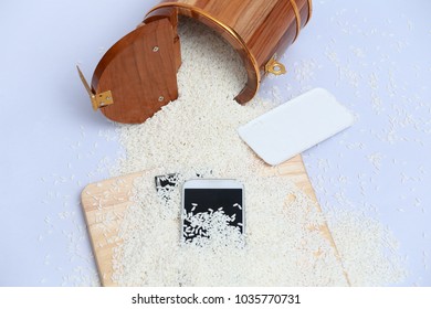 Wet Phone In Rice On Wood And Bucket Rice Background