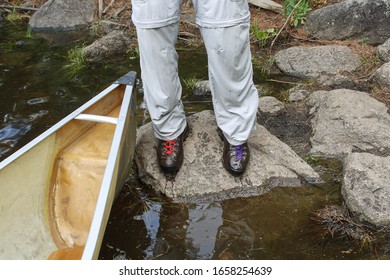 Wet Portsging In The Boundary Waters Canoe Area Wilderness In Northern Minnesota.