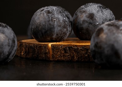 wet ripe purple plum on the table, dark purple plum fruits in drops of water close up - Powered by Shutterstock