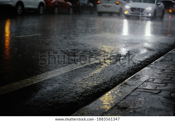 Wet road after hard\
rain fall at night  in the city.Selective focus and shallow depth\
of field composition.