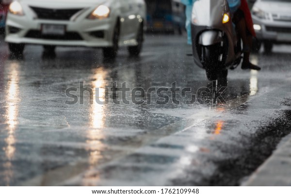 Wet road in the city with light\
reflections,twilight scene after hard rain\
fall.
