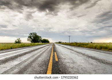 Wet Rural Road With Cloudy Sky