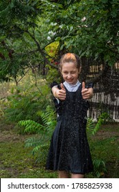 Wet Schoolgirl Standing In The Rain. Girl Wet. Teenager In School Uniform In Spring Or Warm Autumn. Girl 5th Grade. Hair Coloring. Portrait Of A Schoolgirl With Splashes Of Water. Back To School