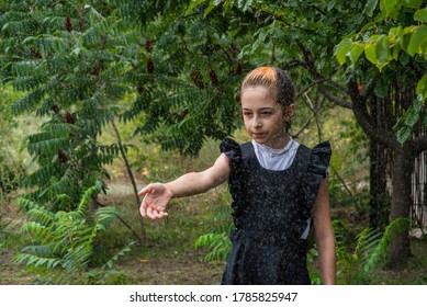 Wet Schoolgirl Standing In The Rain. Girl Wet. Teenager In School Uniform In Spring Or Warm Autumn. Girl 5th Grade. Hair Coloring. Portrait Of A Schoolgirl With Splashes Of Water. Back To School