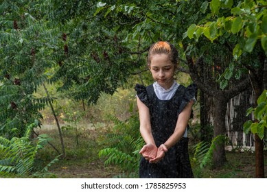 Wet Schoolgirl Standing In The Rain. Girl Wet. Teenager In School Uniform In Spring Or Warm Autumn. Girl 5th Grade. Hair Coloring. Portrait Of A Schoolgirl With Splashes Of Water. Back To School