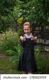 Wet Schoolgirl Standing In The Rain. Girl Wet. Teenager In School Uniform In Spring Or Warm Autumn. Girl 5th Grade. Hair Coloring. Portrait Of A Schoolgirl With Splashes Of Water. Back To School