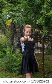 Wet Schoolgirl Standing In The Rain. Girl Wet. Teenager In School Uniform In Spring Or Warm Autumn. Girl 5th Grade. Hair Coloring. Portrait Of A Schoolgirl With Splashes Of Water. Back To School