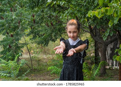 Wet Schoolgirl Standing In The Rain. Girl Wet. Teenager In School Uniform In Spring Or Warm Autumn. Girl 5th Grade. Hair Coloring. Portrait Of A Schoolgirl With Splashes Of Water. Back To School