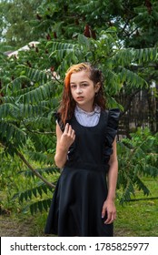 Wet Schoolgirl Standing In The Rain. Girl Wet. Teenager In School Uniform In Spring Or Warm Autumn. Girl 5th Grade. Hair Coloring. Portrait Of A Schoolgirl With Splashes Of Water. Back To School